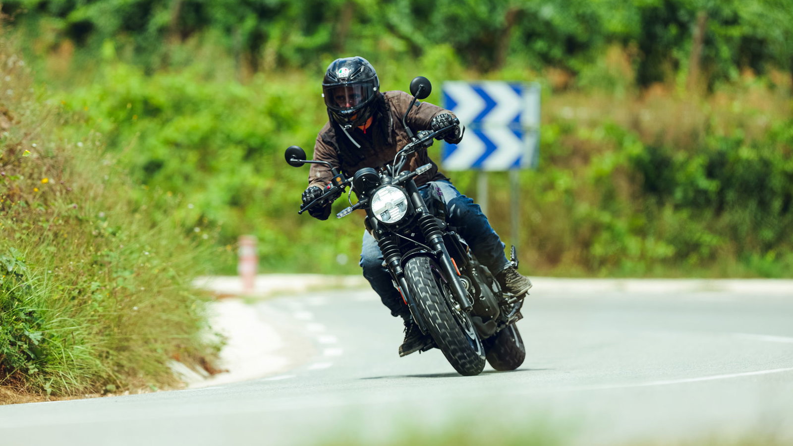 A motorcycle riding around a bend in the road