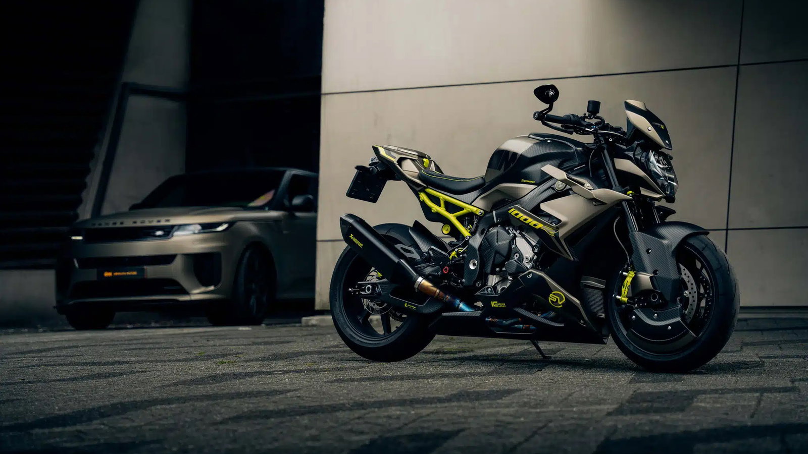 A custom BMW motorcycle and a Range Rover Sport SV
