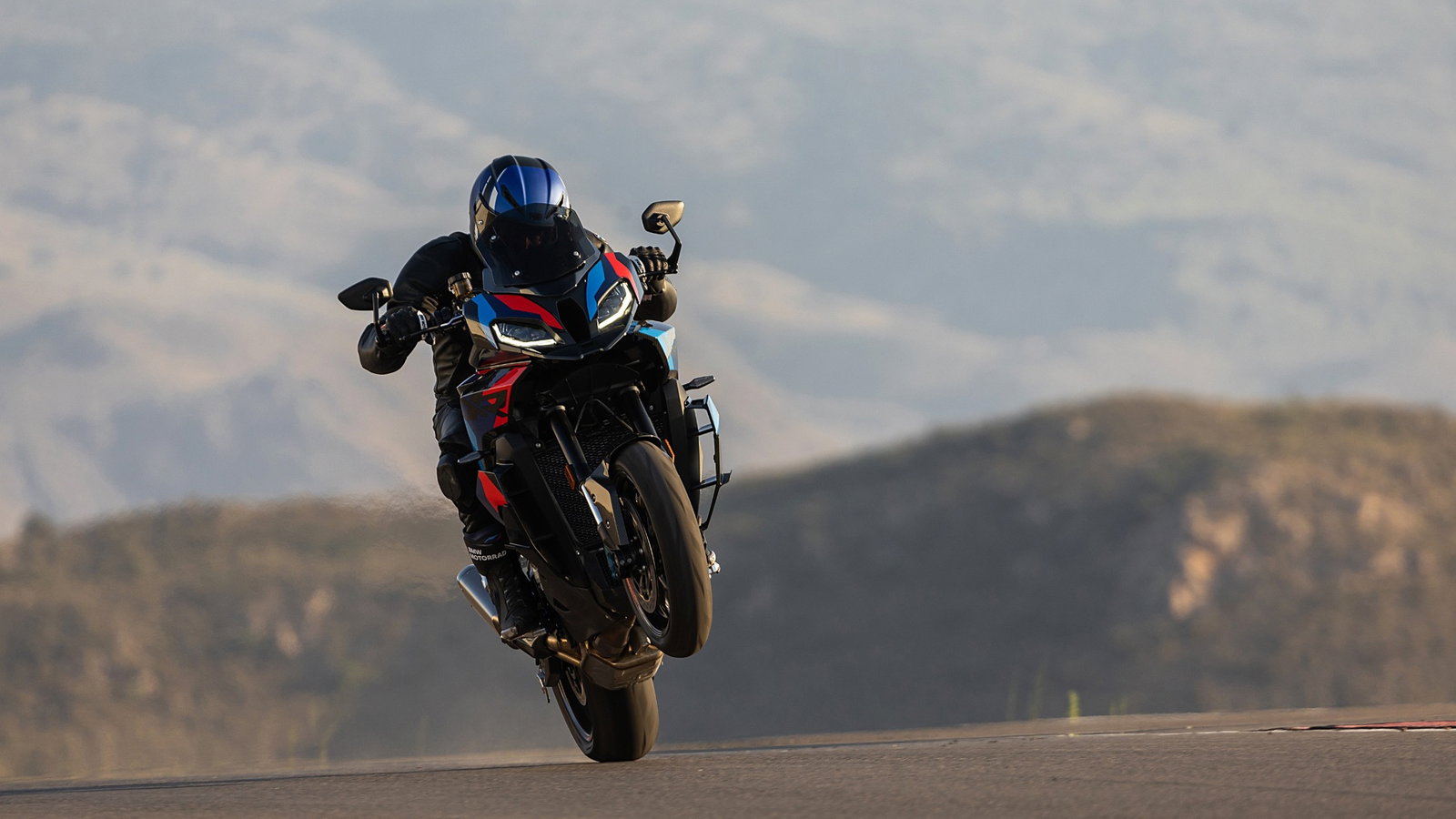 A BMW M1000 XR being ridden on track