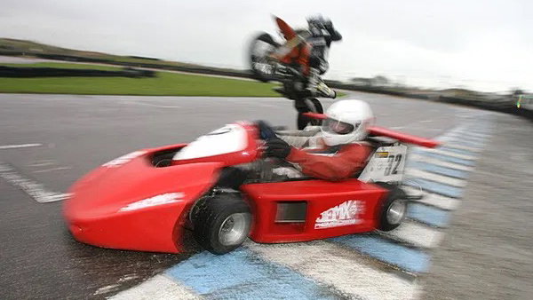 A KTM 450 races a 250cc Superkart