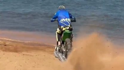 Motocross rider goes surfing on his motorcycle