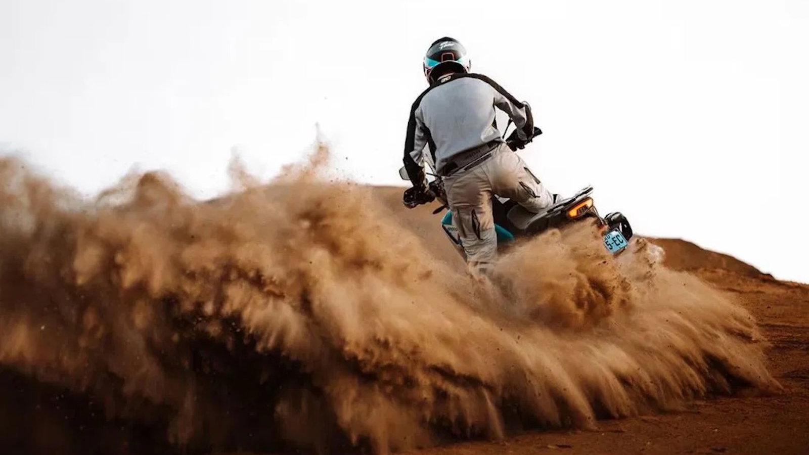 A CFMoto adventure bike riding in the sand