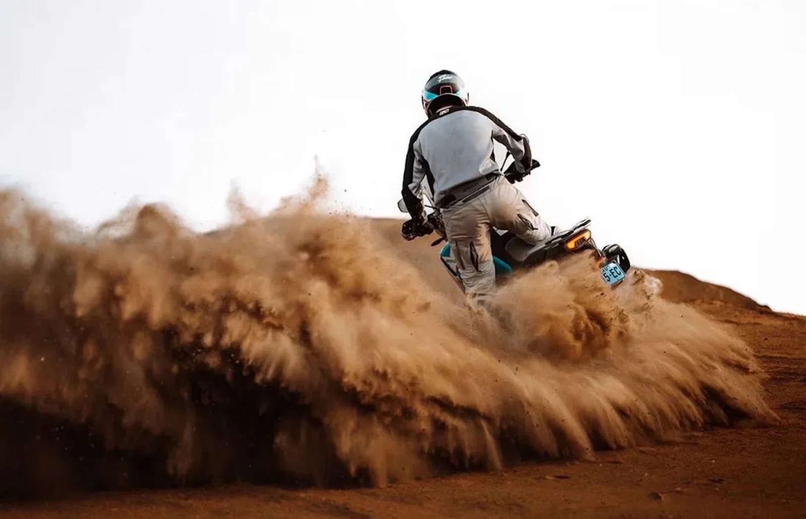 A CFMoto adventure bike riding in the sand