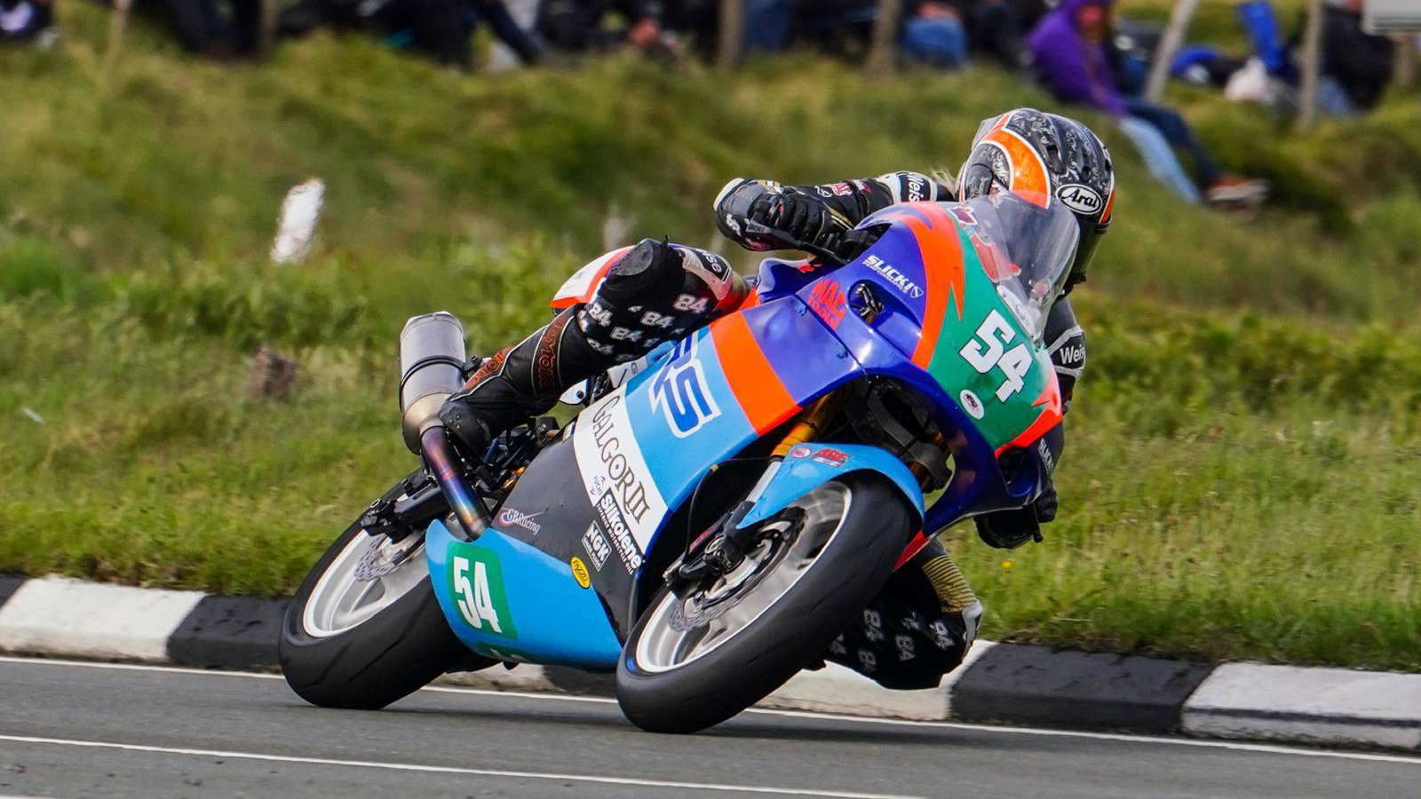 Maria Costello riding a motorcycle at the TT. Photo credit - Iconic Auctioneers