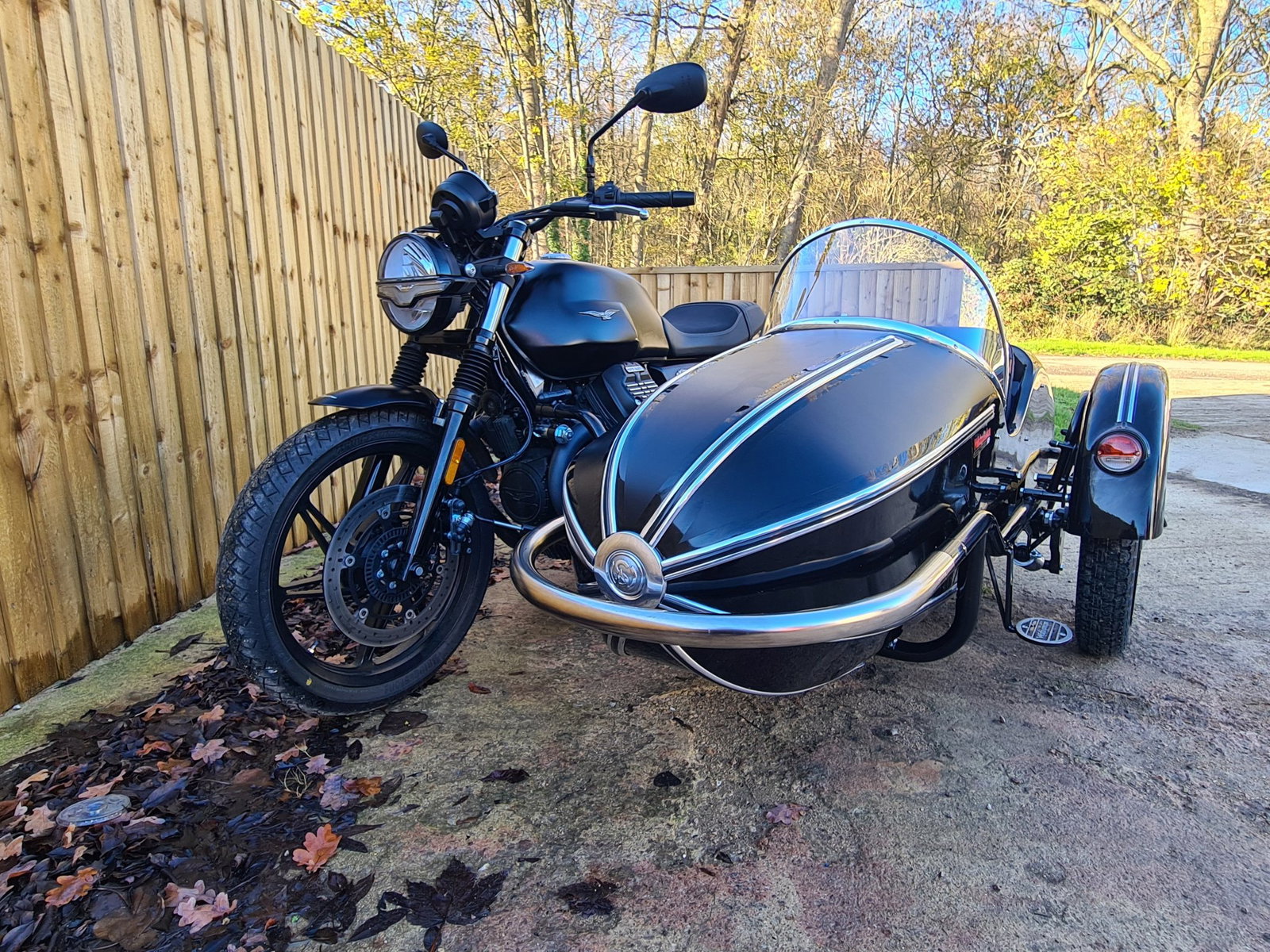 A black Watsonian sidecar fitted to a Moto Guzzi motorcycle
