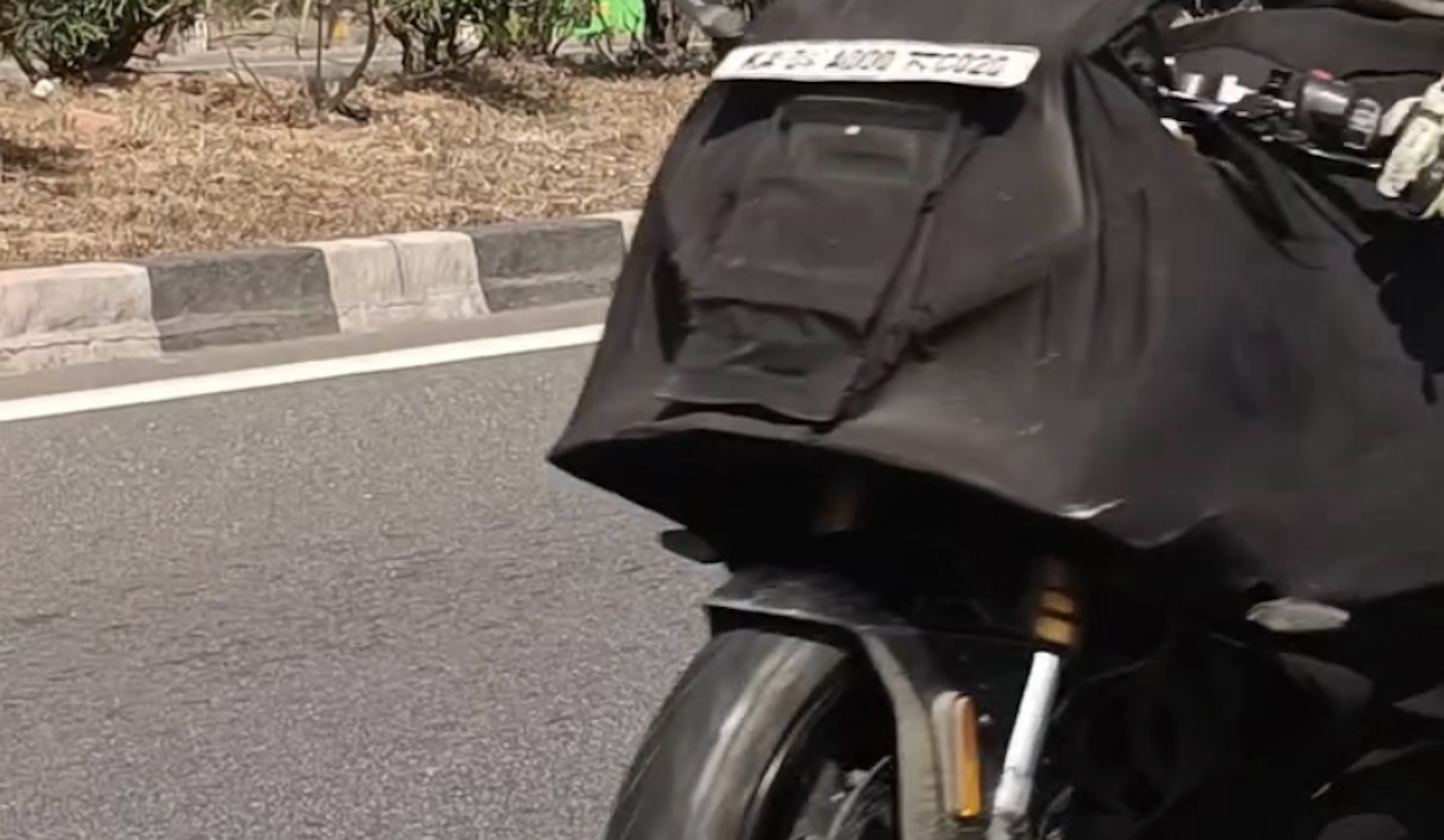 TVS Apache RR 450 under black cover. Credit: Facebook/Bikewale.