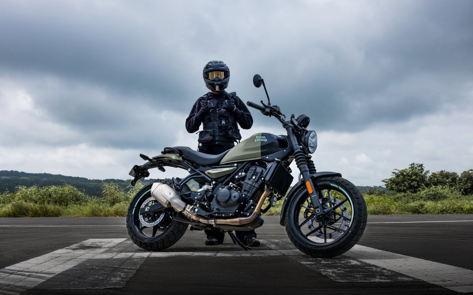 A rider standing behind a Guerrilla 450 motorcycle