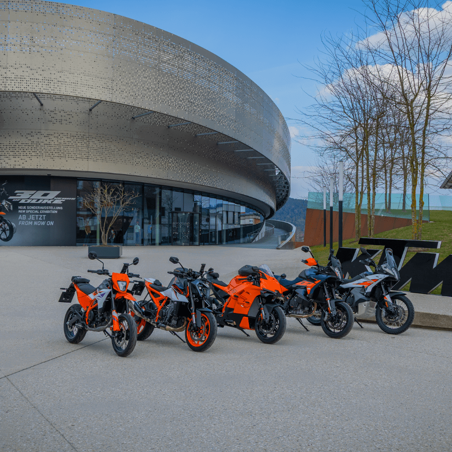 KTM bikes in front of the Motohall
