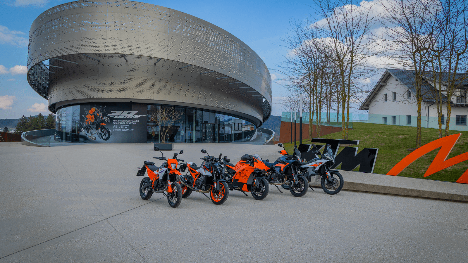 KTM bikes in front of the Motohall