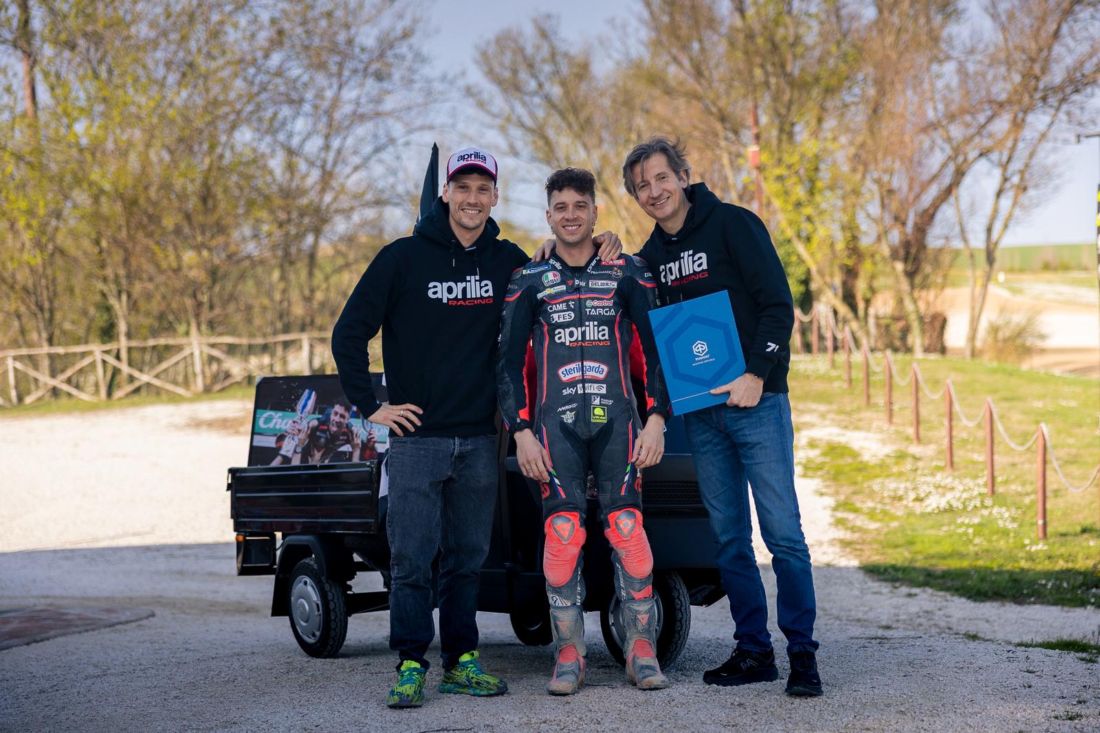 Lorenzo Savadori, Marco Bezzecchi, Massimo Rivola with Piaggio Ape. Credit: Aprilia Racing.