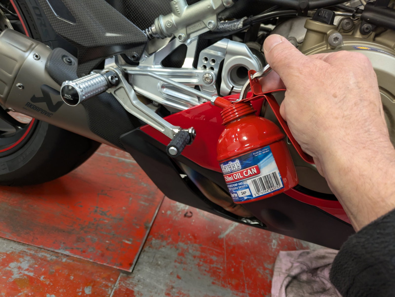 Clarke CHT843 250ml Oil Can being used on a motorcycle.