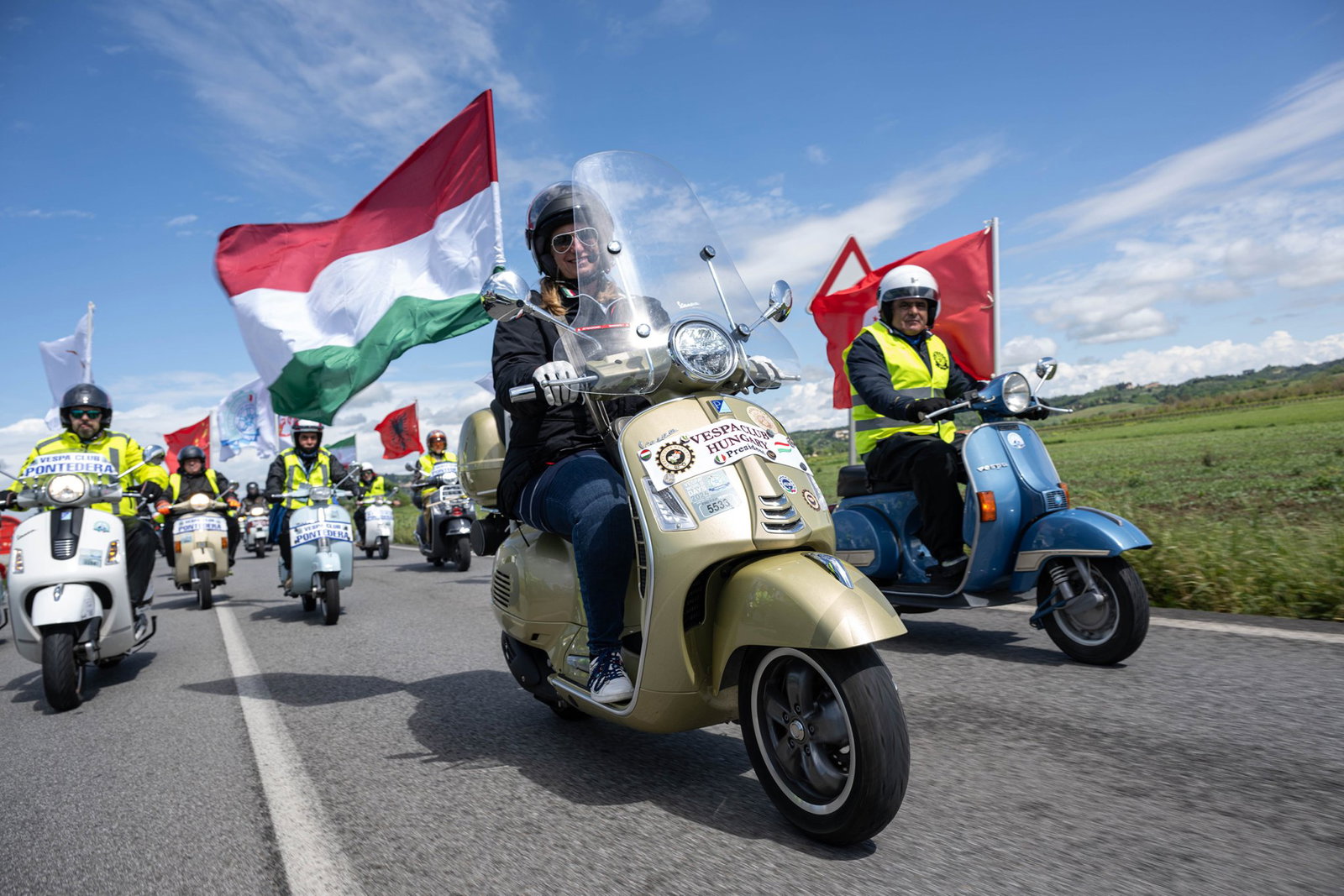 Riders celebrating the Vespa brand together.
