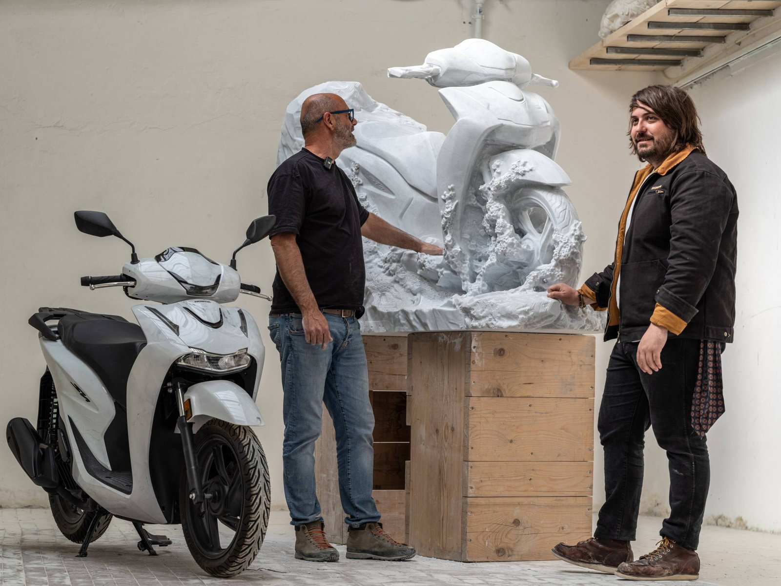 The Honda SH125i 'Marmo concept' and the ‘Hanami’ sculpture side-by-side