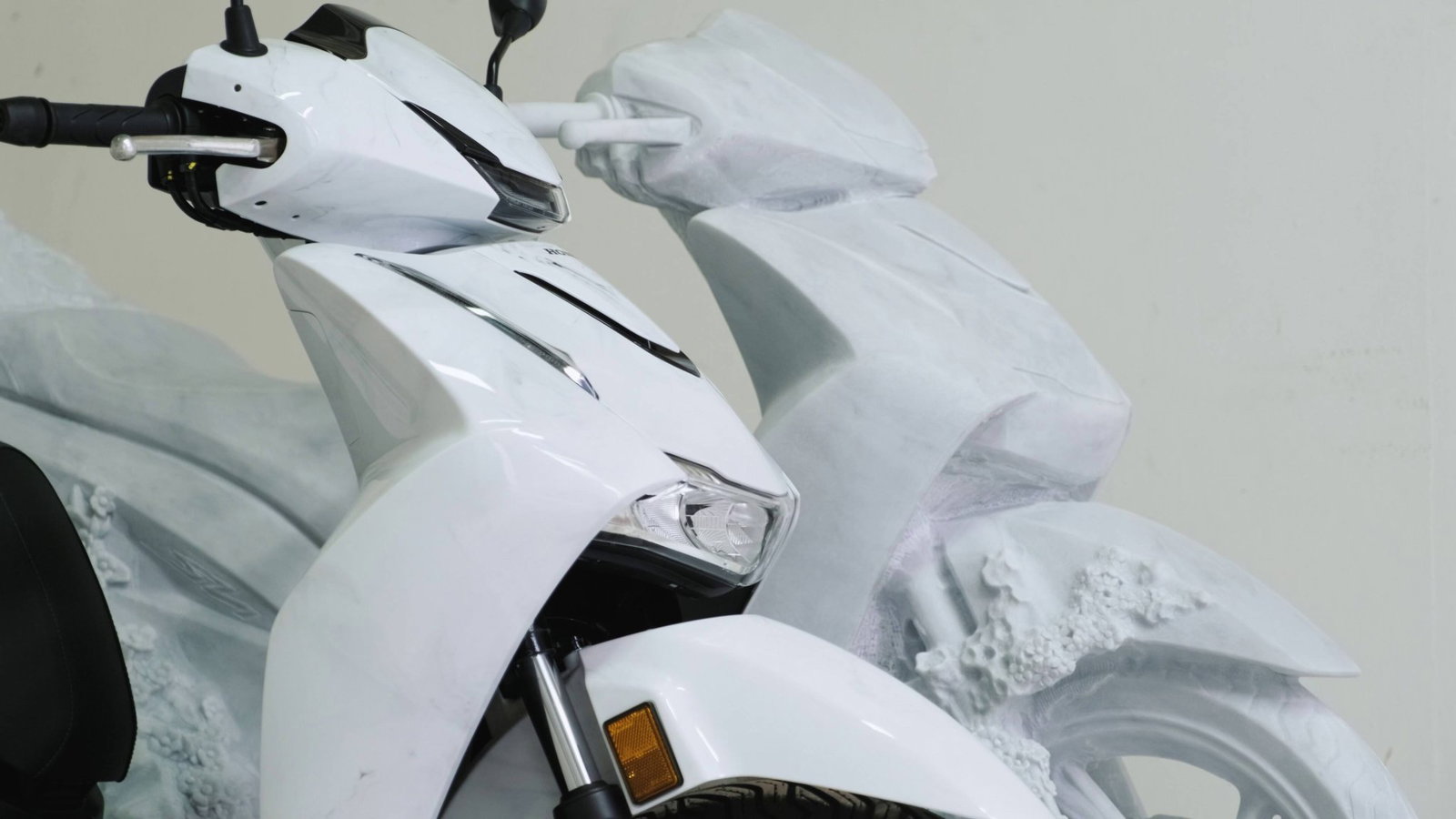 A side view of the sculpture and the actual scooter