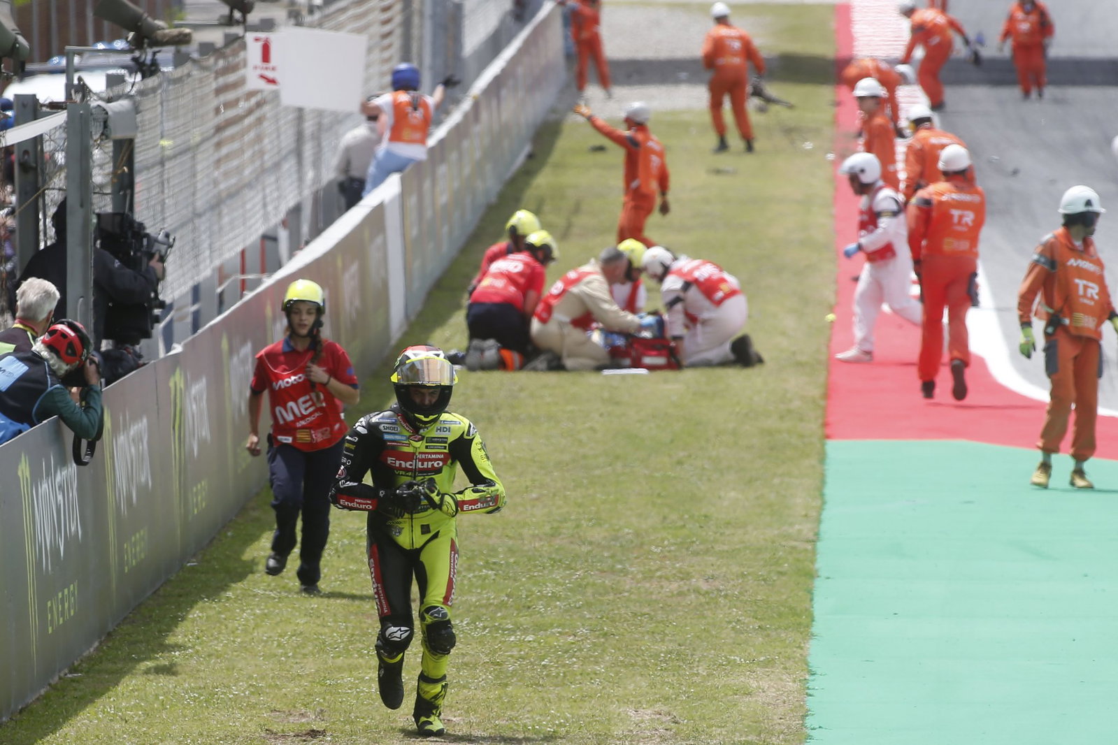 Marshals attending to Alex Marquez in the distance. Credit: Gold and Goose.