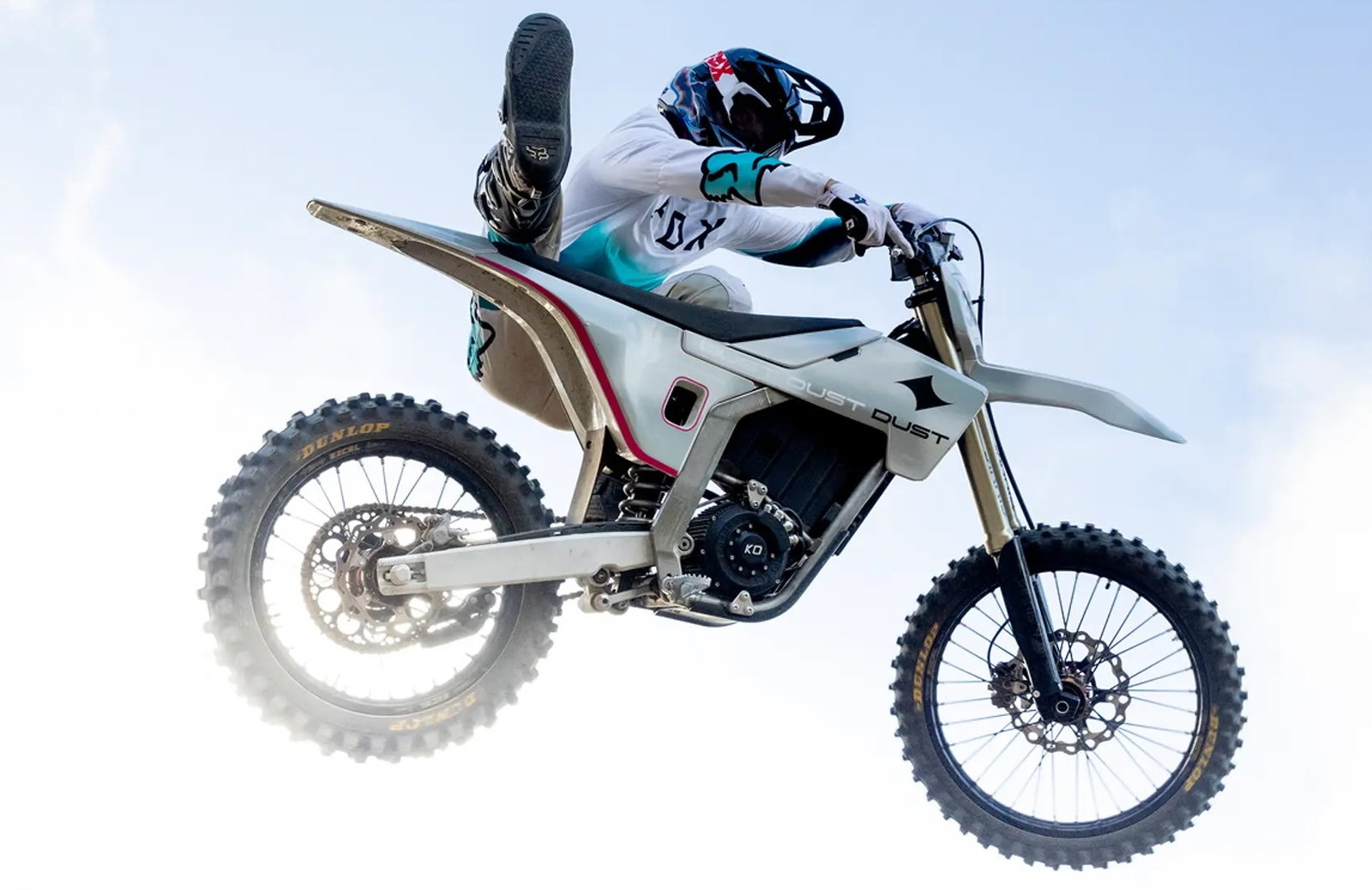 An electric dirt bike flying through the air