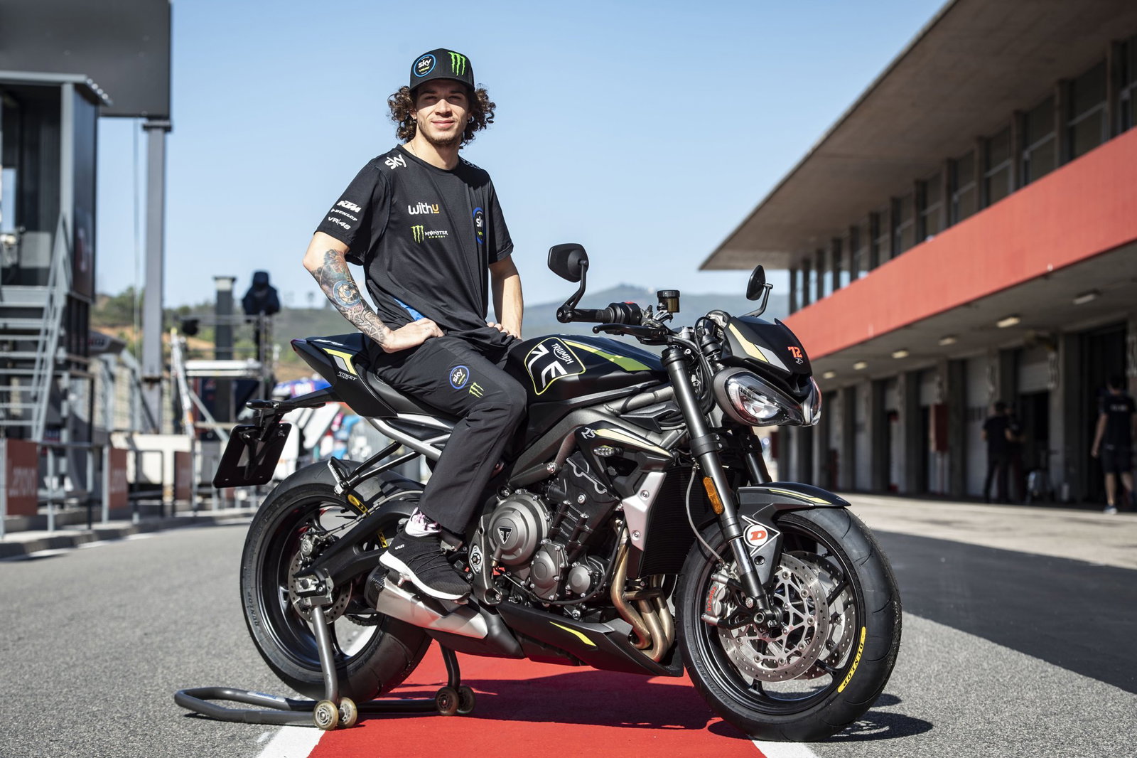 Marco Bezzecchi sitting on a Triumph Street Triple 765