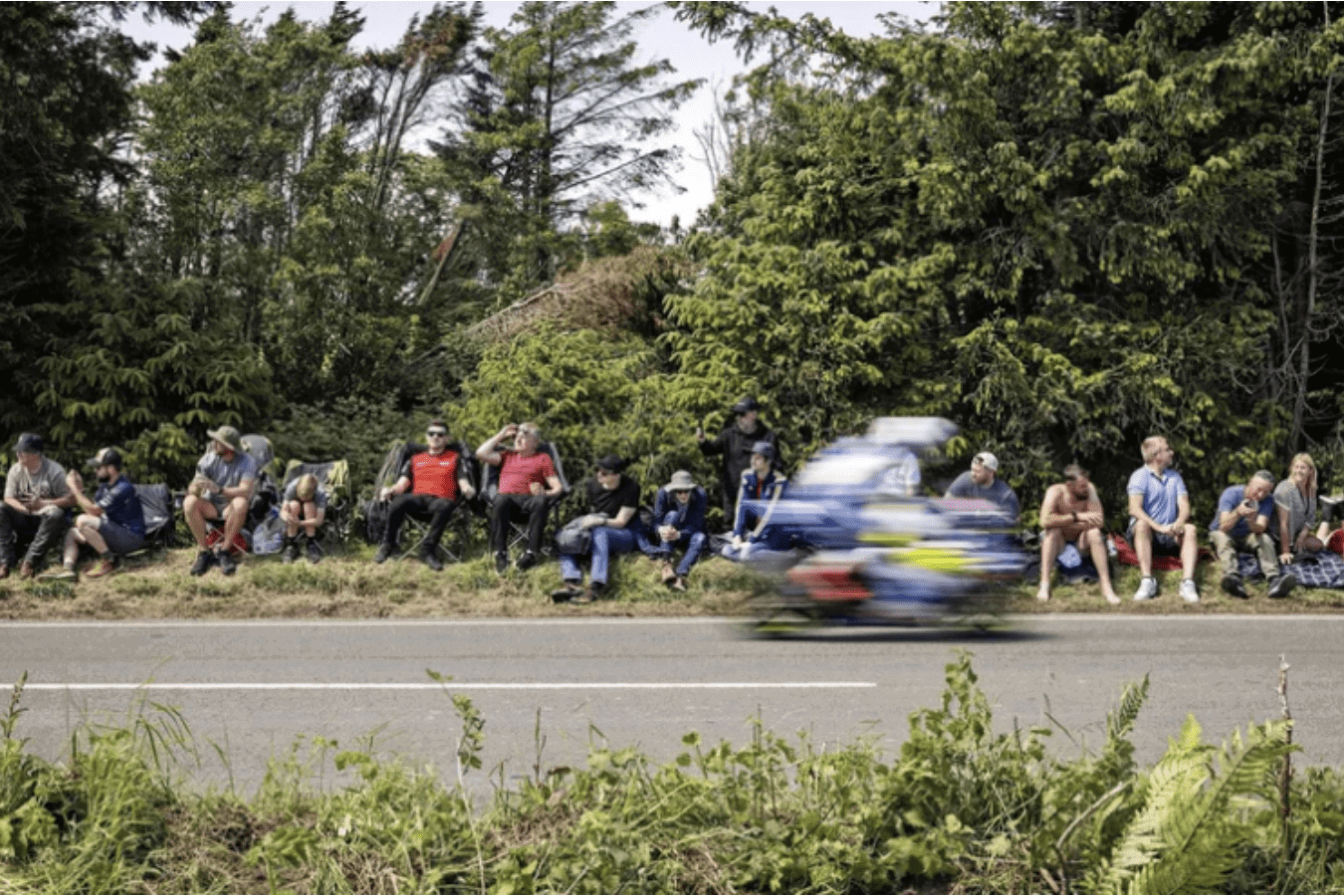 A rider flying past fans at the Isle of Man TT. Credit: Isle of Man TT.