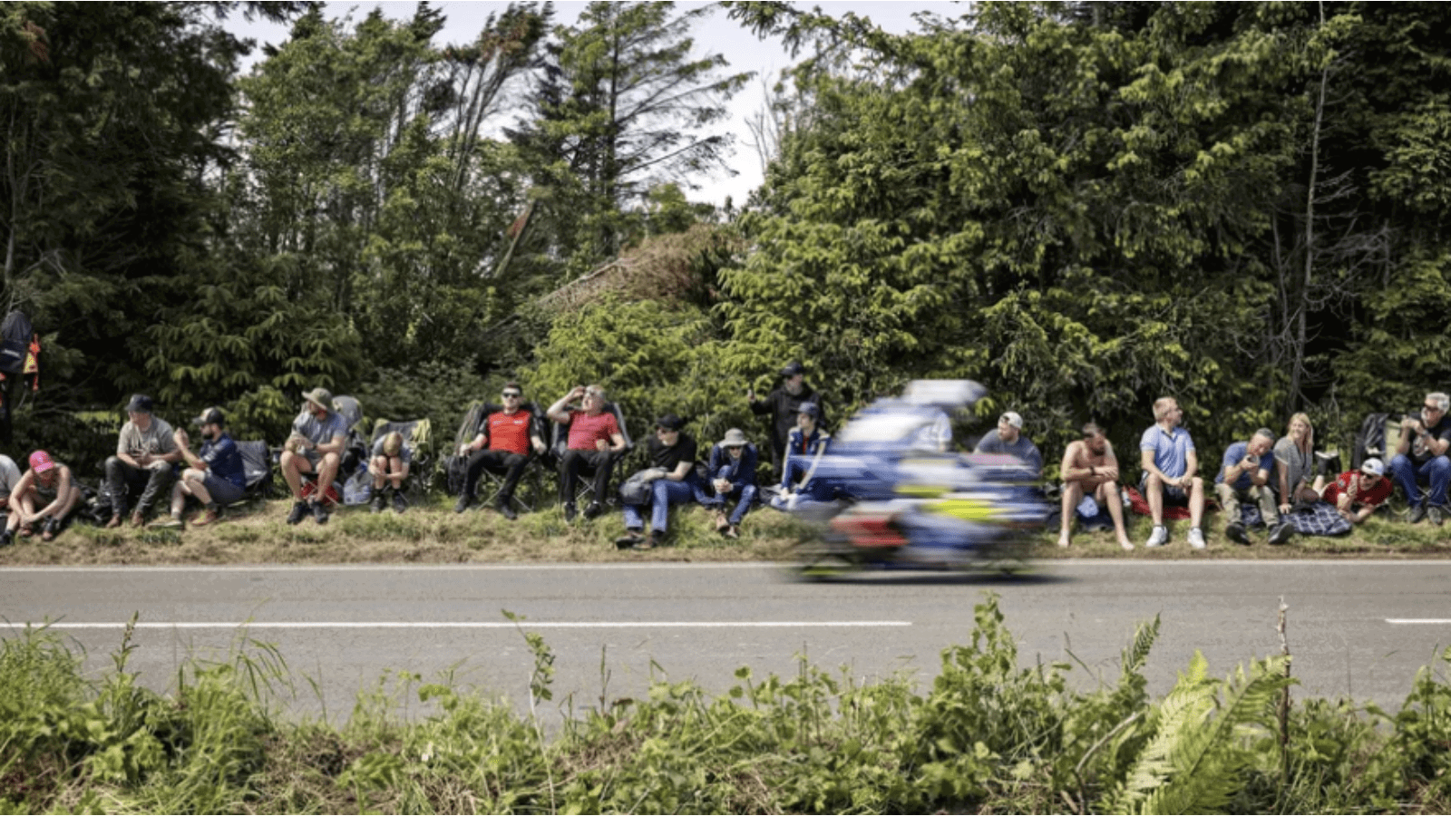 A rider flying past fans at the Isle of Man TT. Credit: Isle of Man TT.