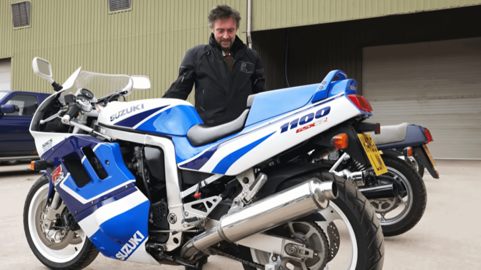 Richard Hammond standing with one of his many motorcycles.