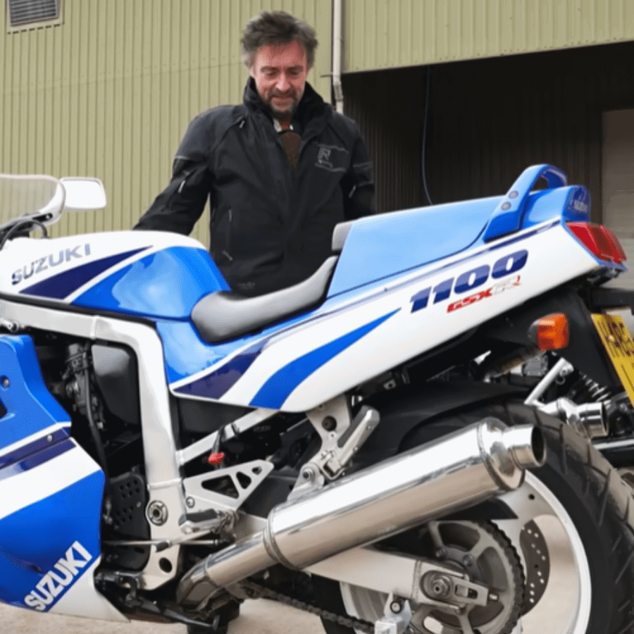 Richard Hammond standing with one of his many motorcycles.