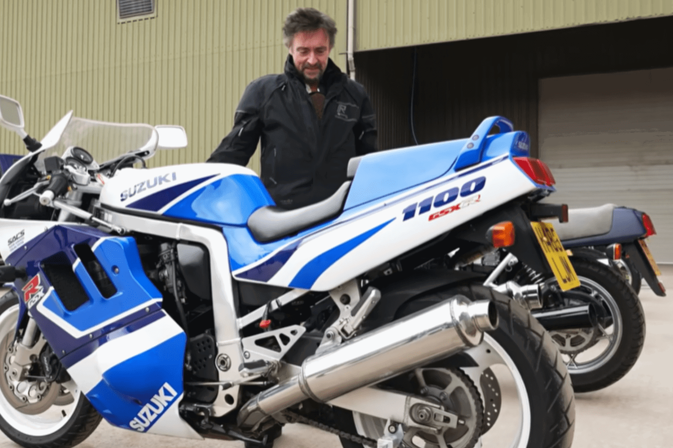 Richard Hammond standing with one of his many motorcycles.