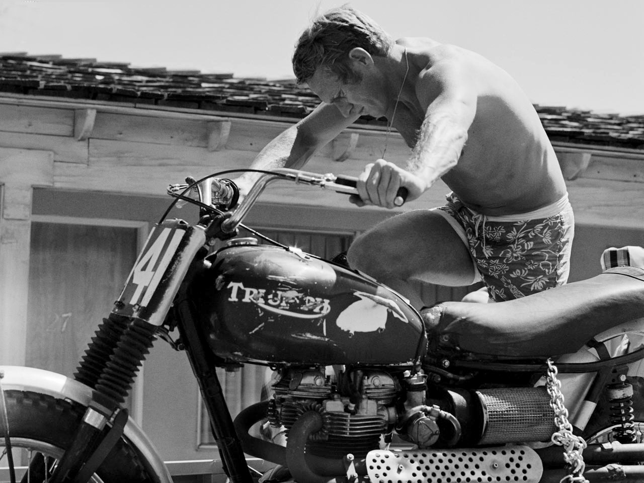 Steve McQueen with a Triumph motorcycle.