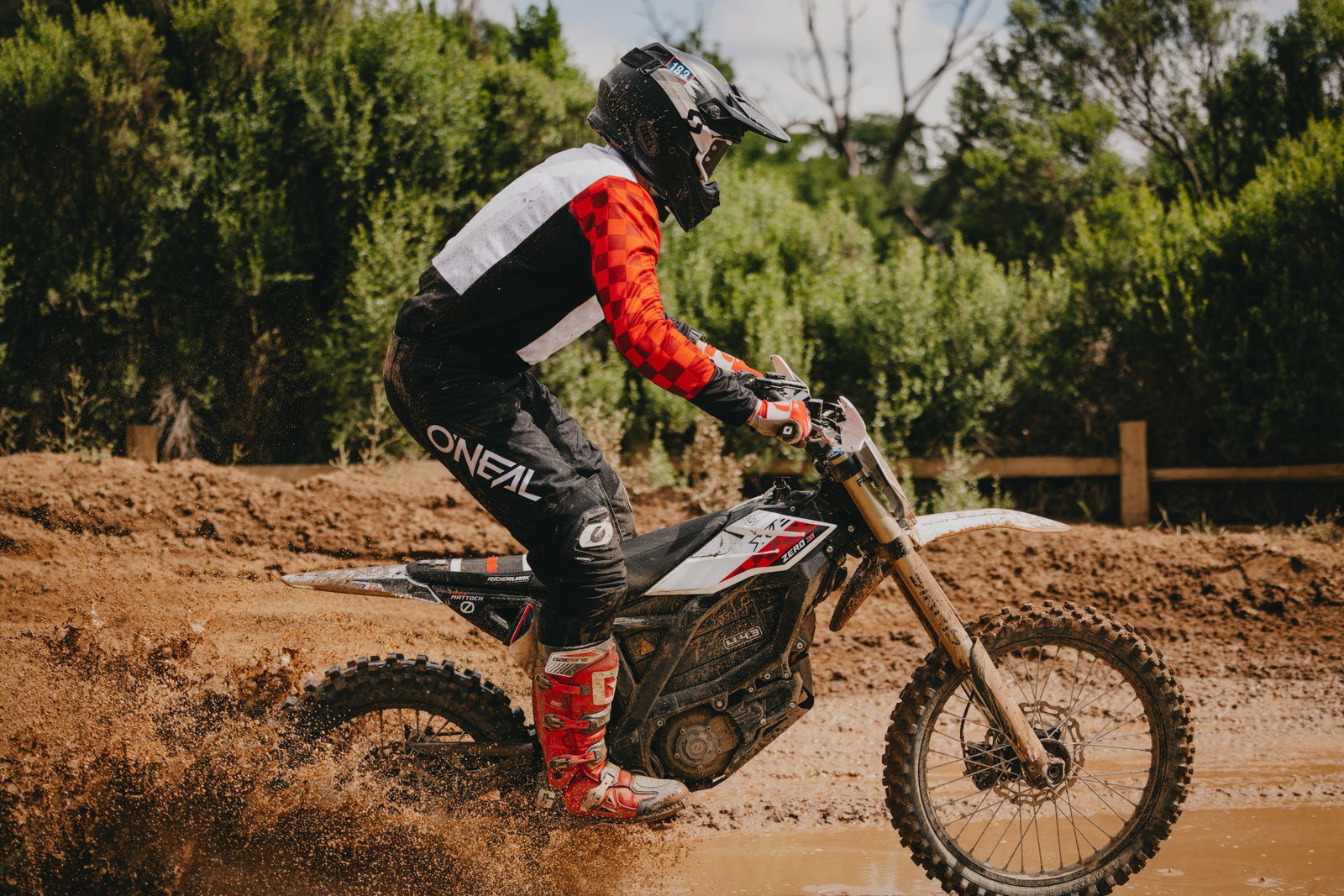 A Zero e-bike riding through mud