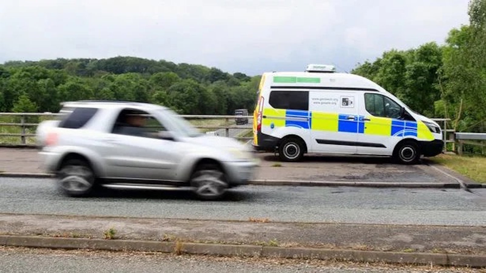 a speed camera van and a speeding car