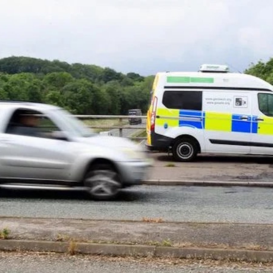 a speed camera van and a speeding car