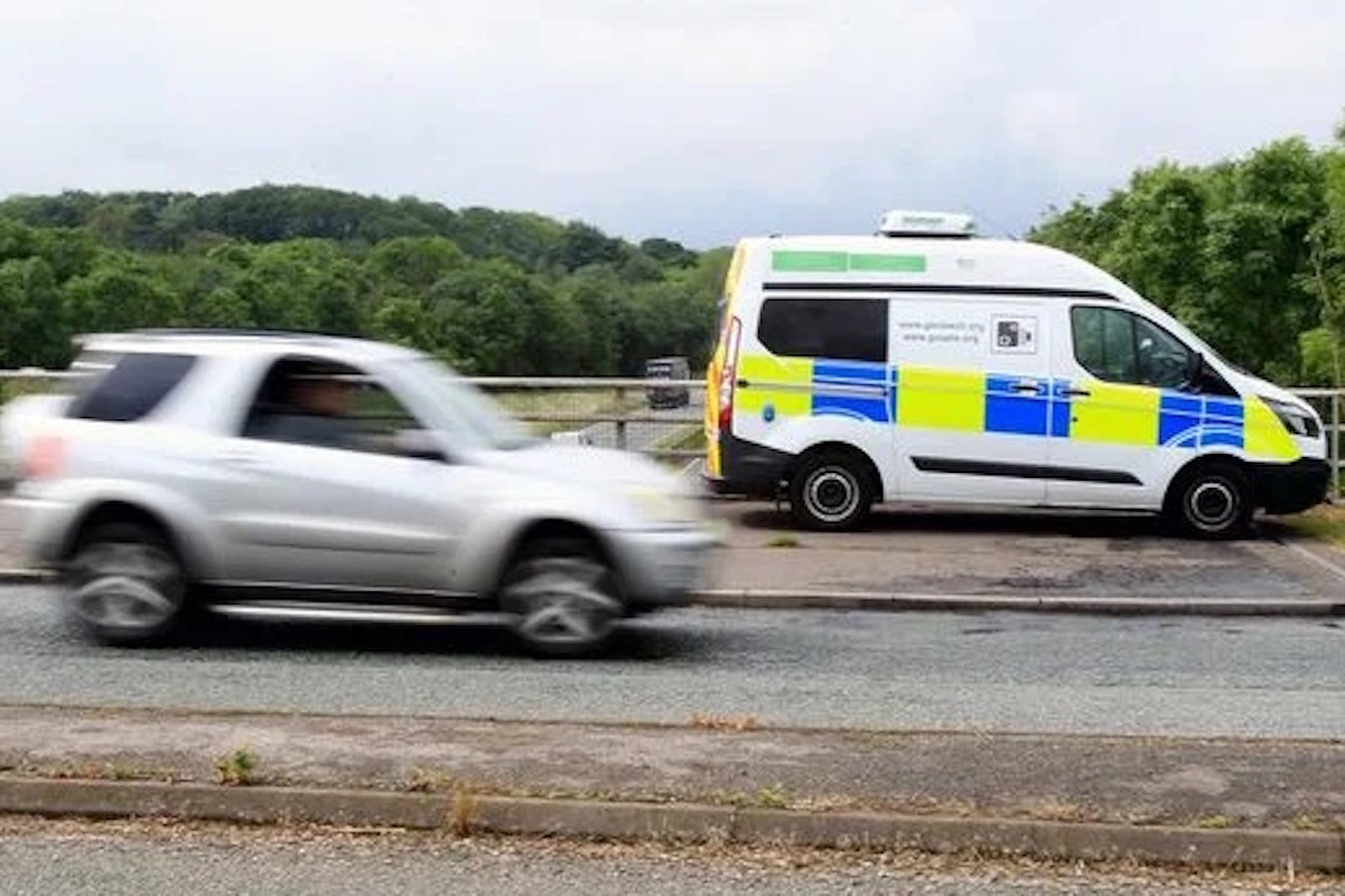 a speed camera van and a speeding car