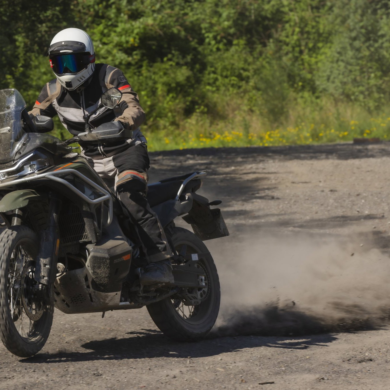 The CFMoto 1000MT-X power sliding in dust