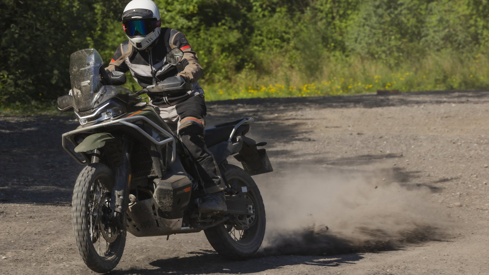 The CFMoto 1000MT-X power sliding in dust
