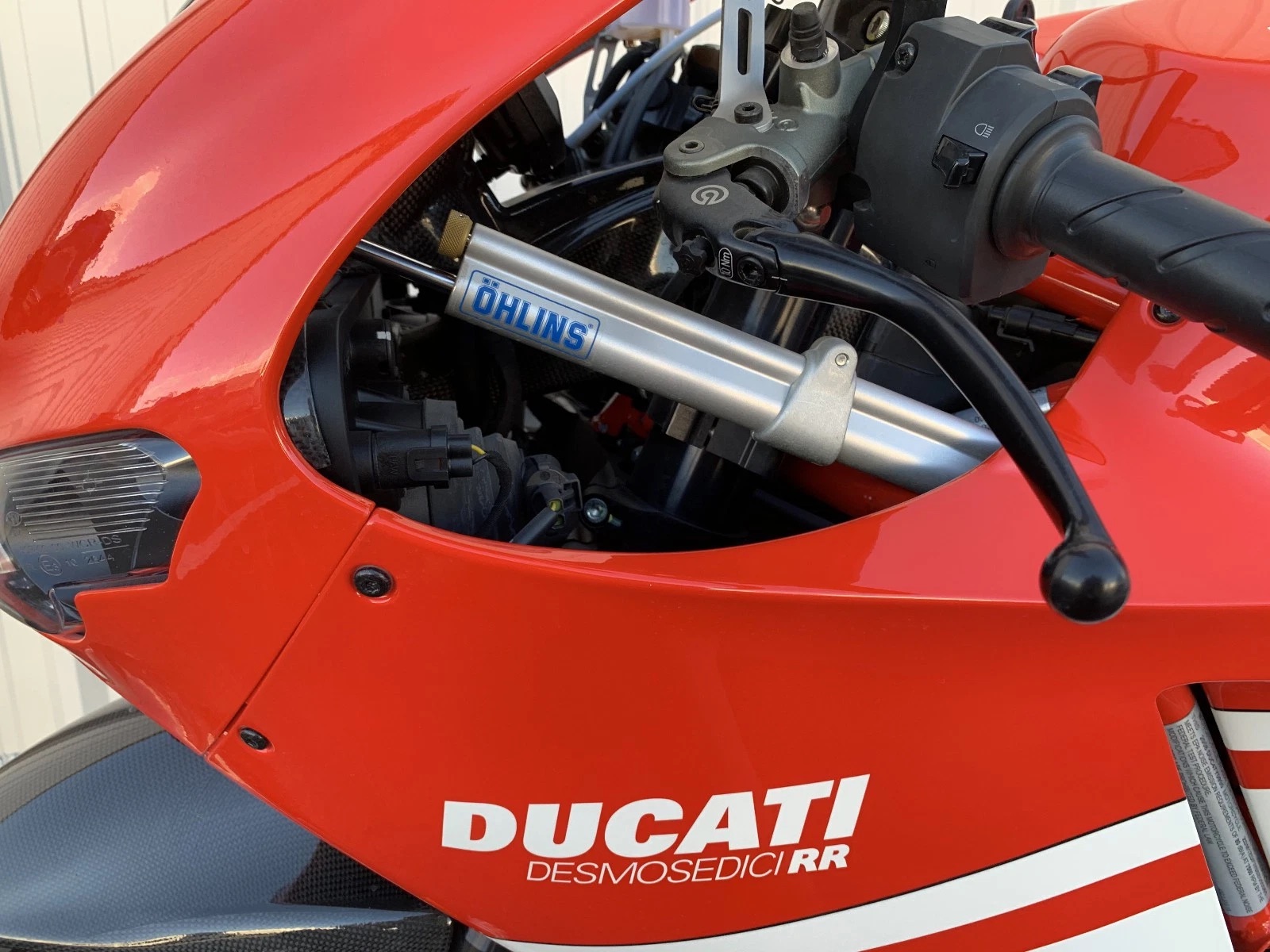 An Ohlins steering damper is also present