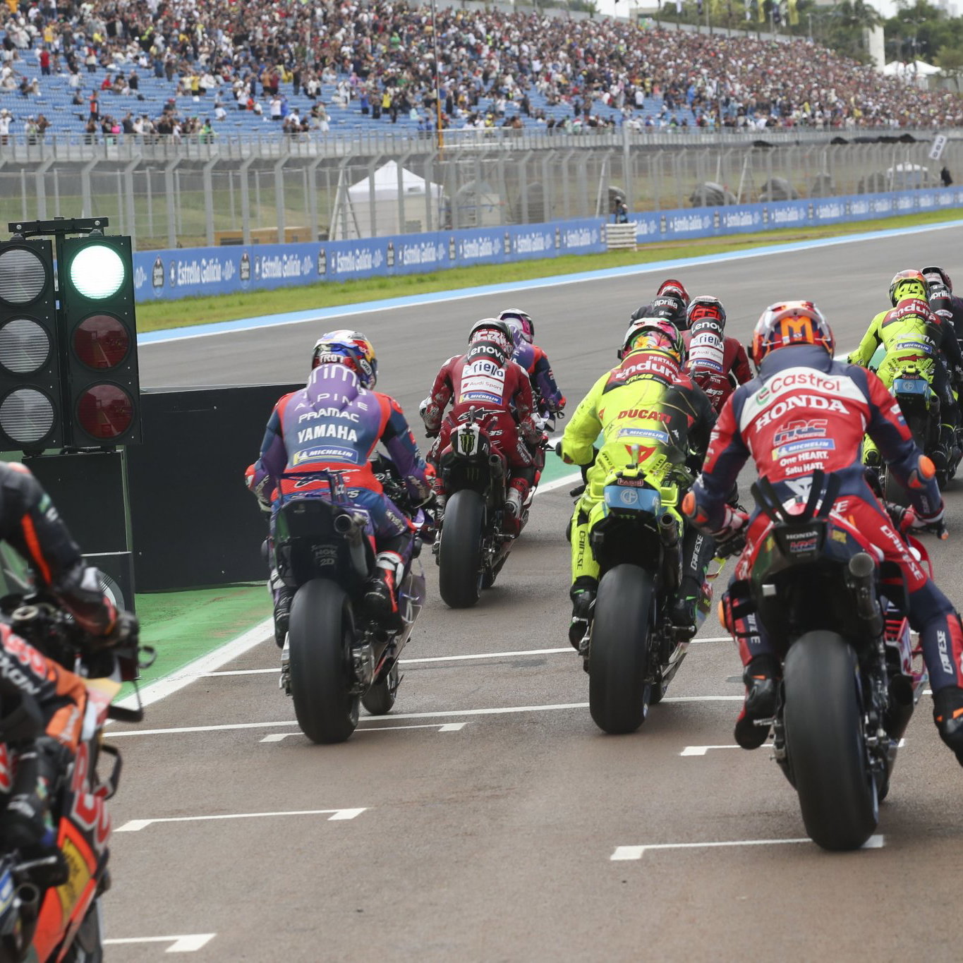 MotoGP riders exiting pit lane. Credit: Gold and Goose.
