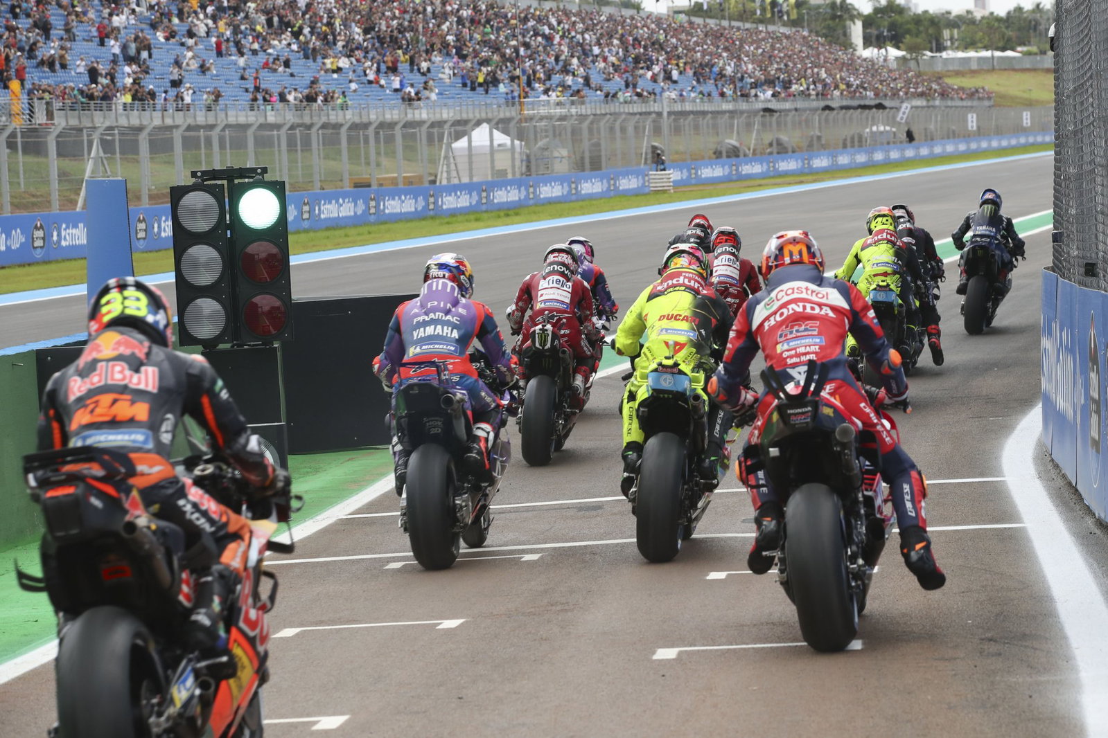MotoGP riders exiting pit lane. Credit: Gold and Goose.