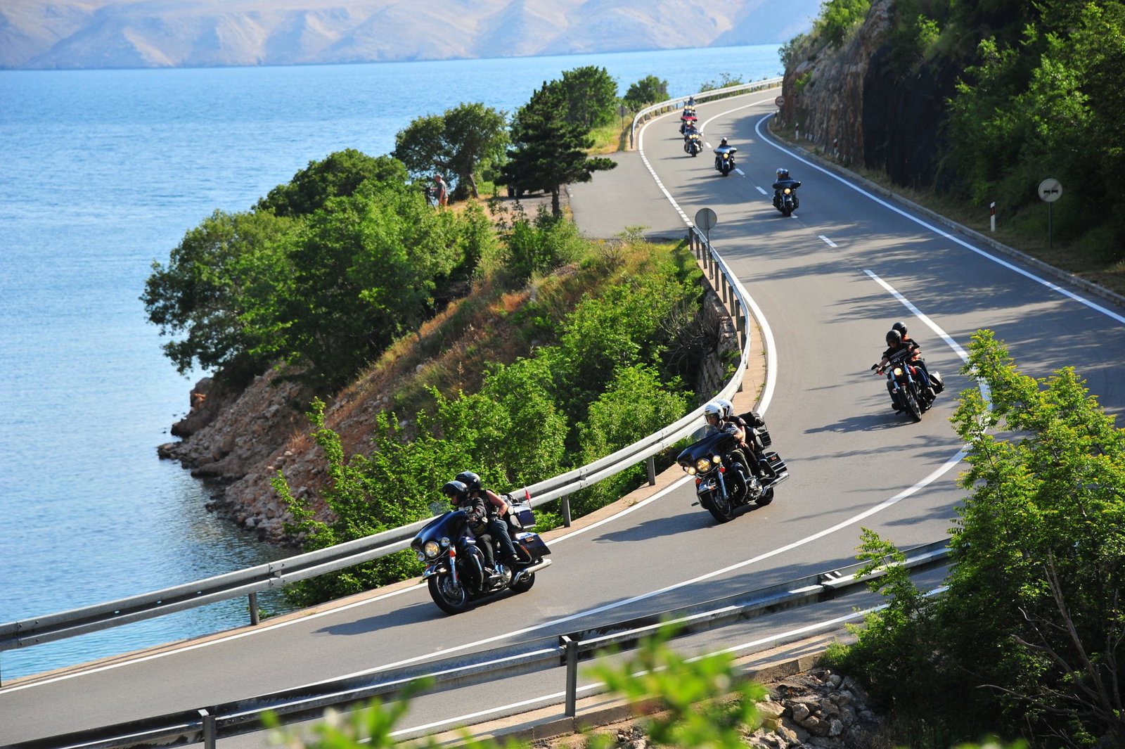 Harley motorbikes riding on the road.