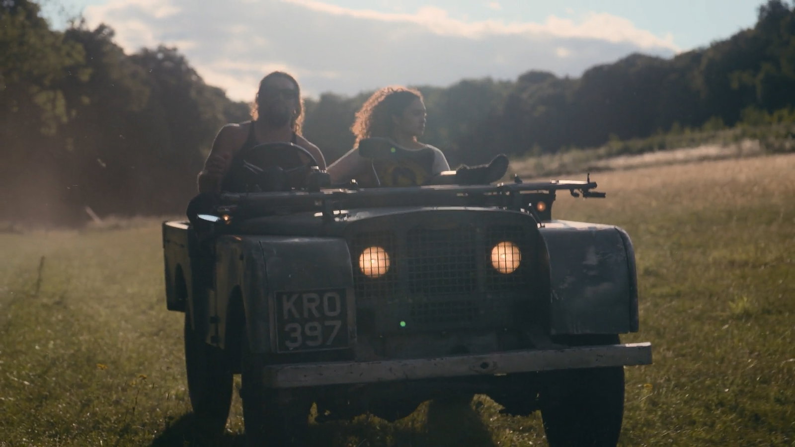 Momoa driving a classic Land Rover