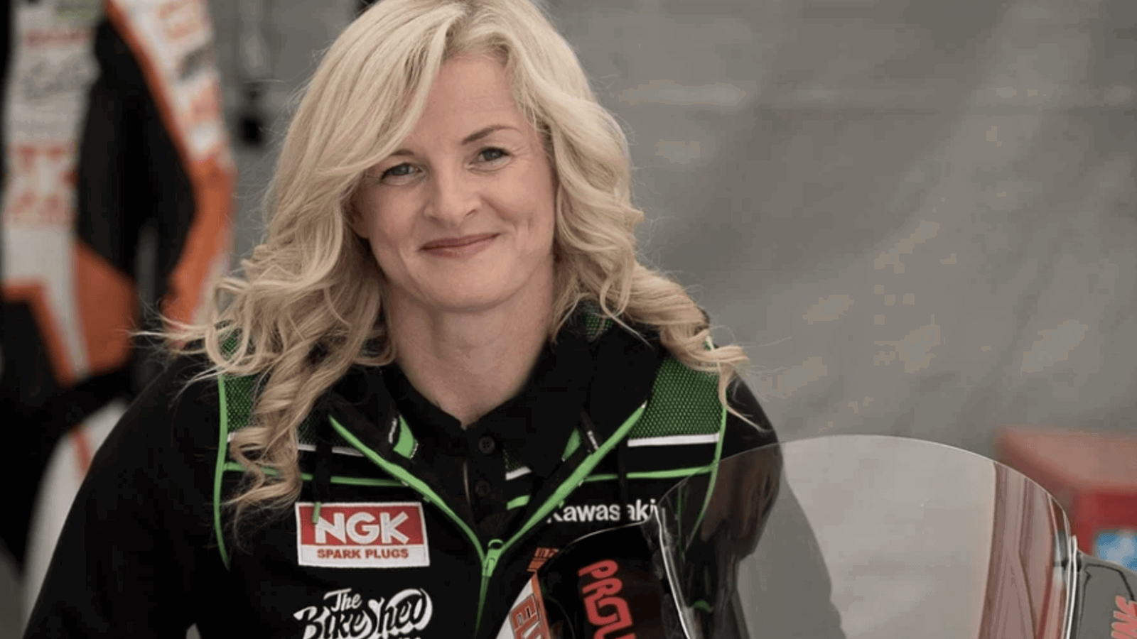 Maria Costello standing with one of her race bikes.