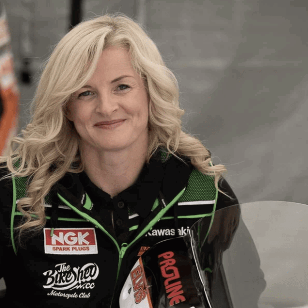 Maria Costello standing with one of her race bikes.