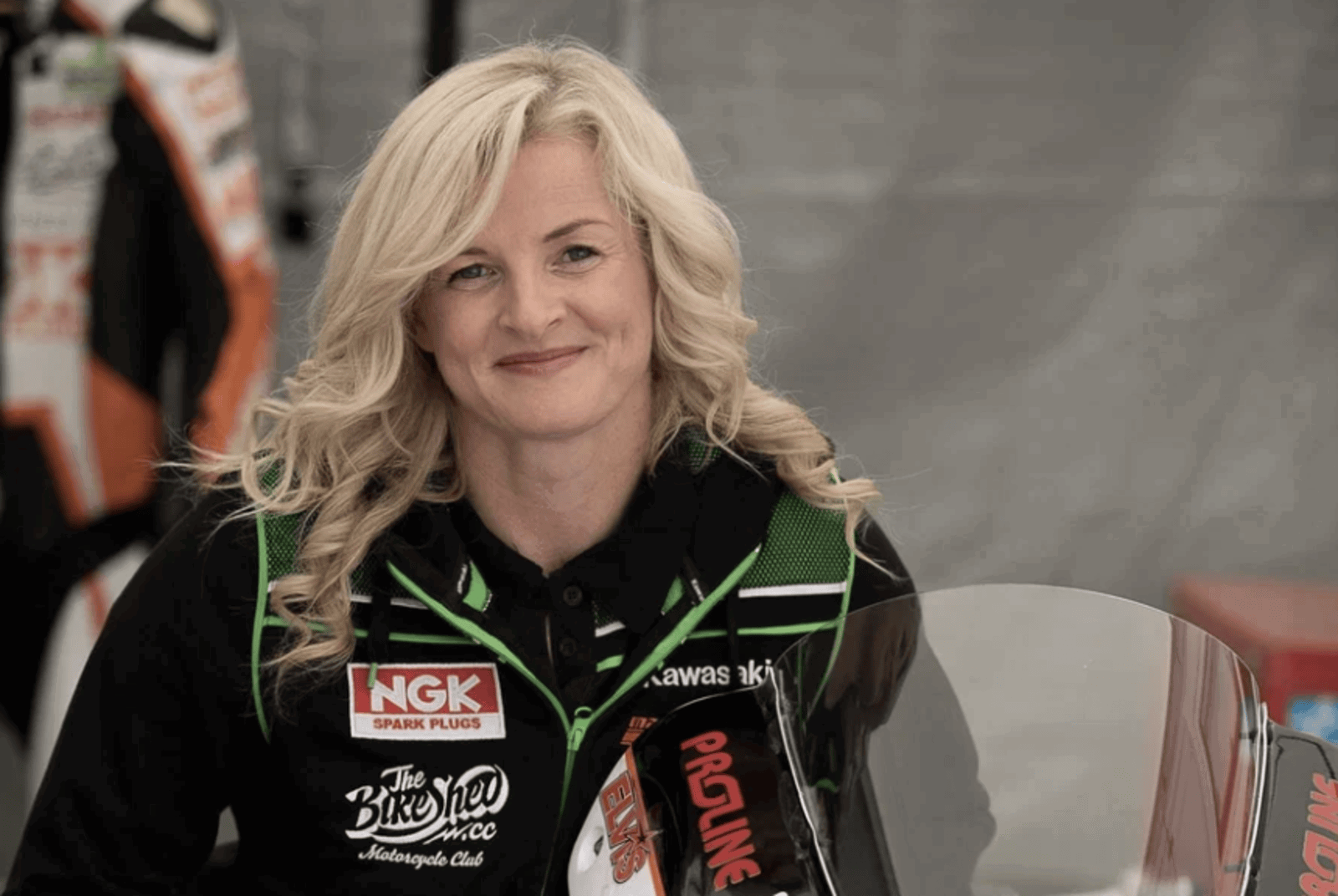 Maria Costello standing with one of her race bikes.