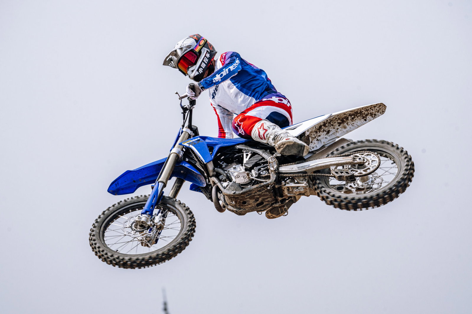 The ZXMoto MX250 flying off a jump