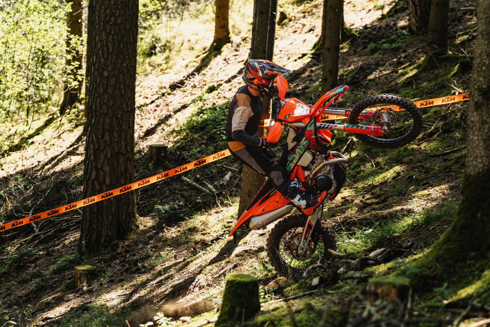 KTM EXC enduro motorcycle on one wheel.