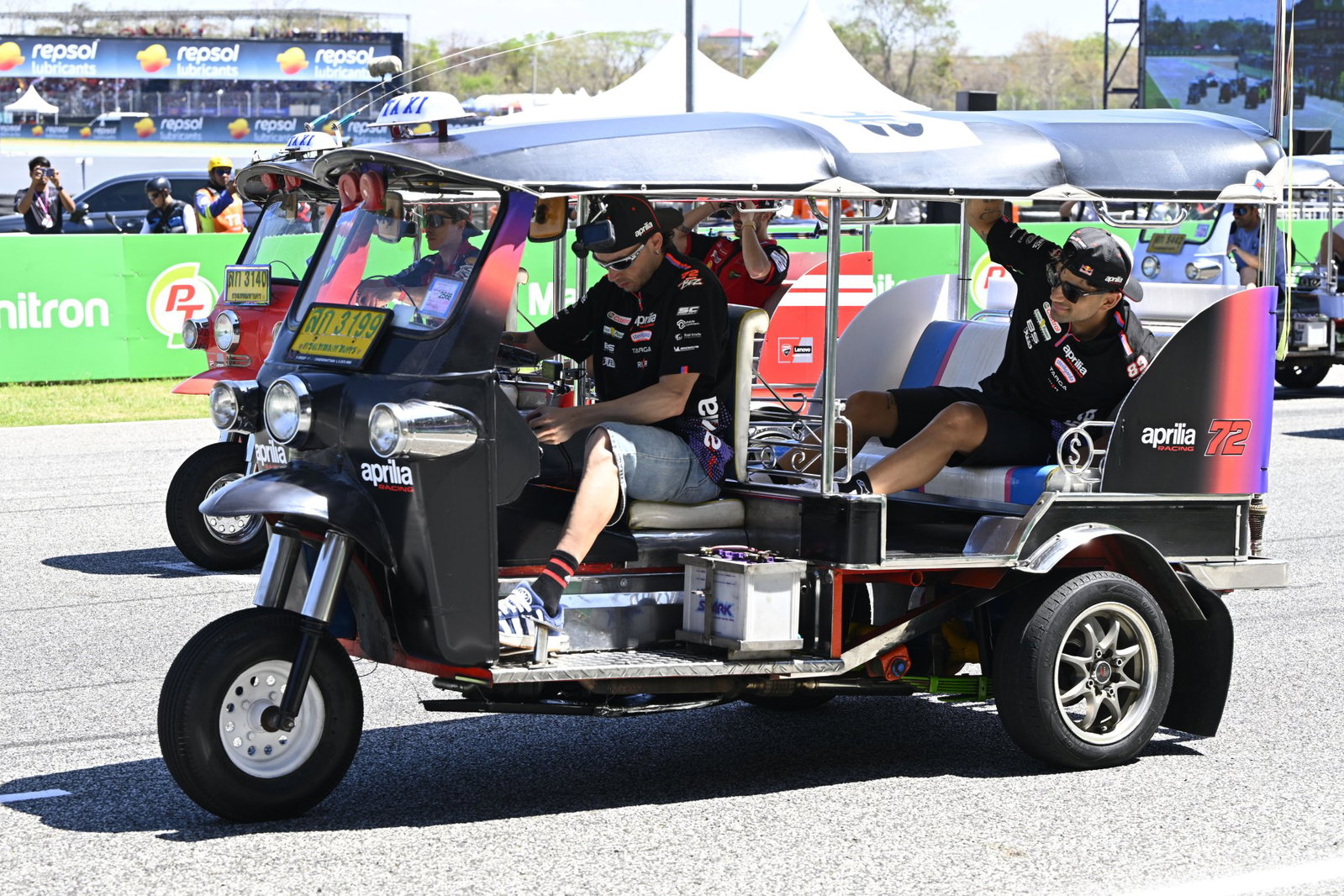MotoGP riders taking part in a Tuk Tuk race in Thailand. Credit: Gold and Goose.