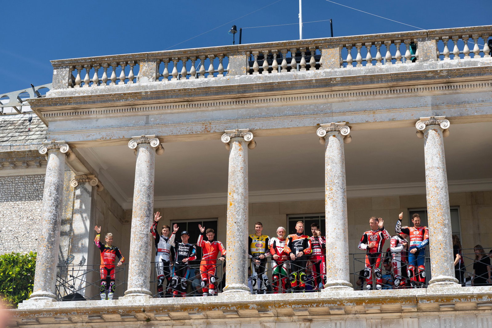 Ducati riders celebrate Goodwood balcony moment.