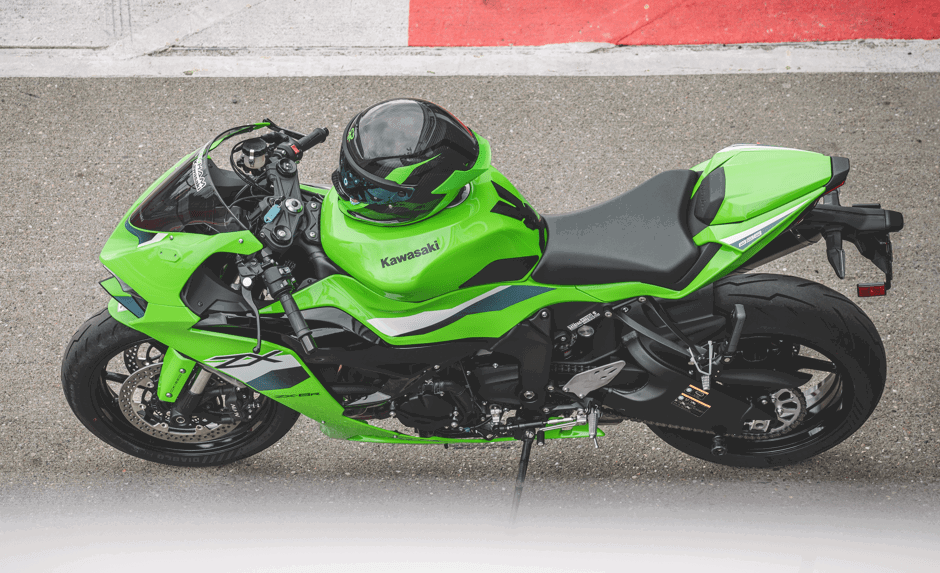 Ruroc AT4 Track Verde resting on a Kawasaki.