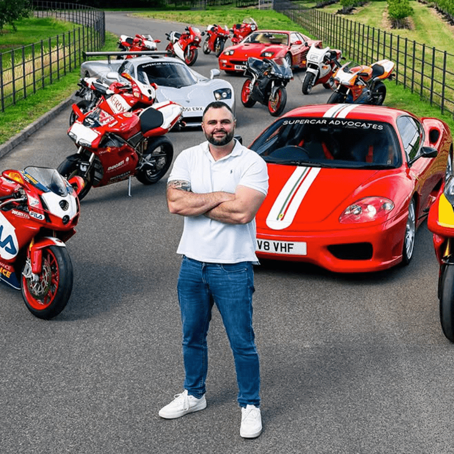 Lee Khouri standing with some of his two and four-wheel collection. Credit: Ducati.