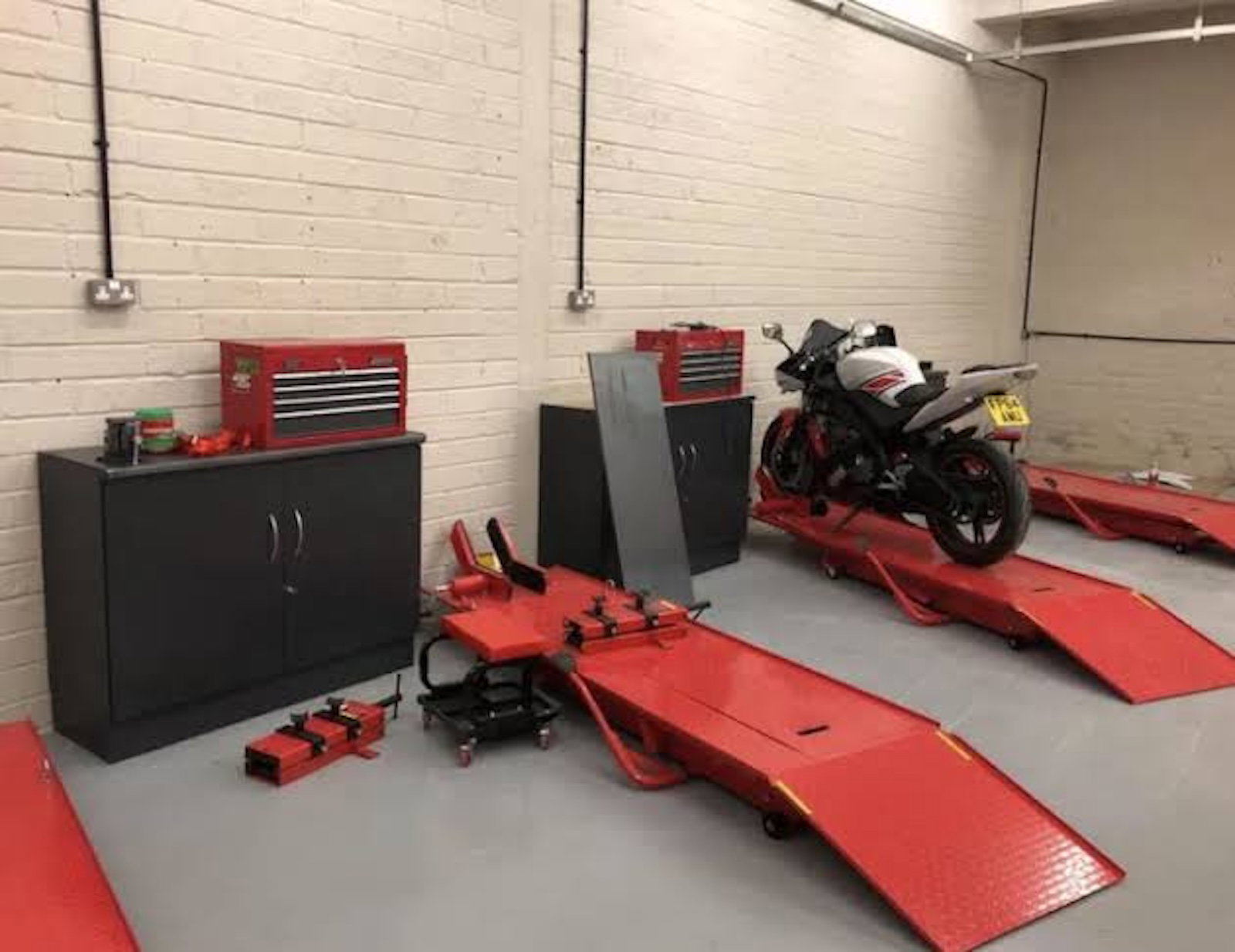 A motorcycle on a bike ramp in a workshop