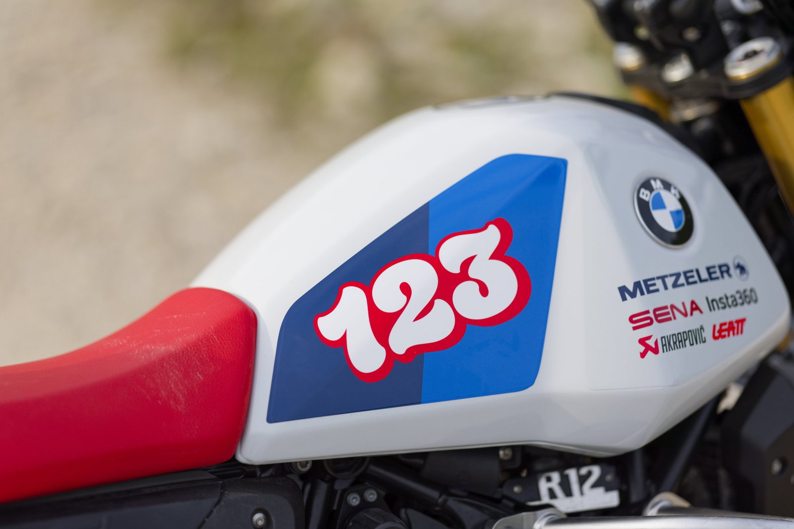 A BMW GS with Sena and Metzeler branding.