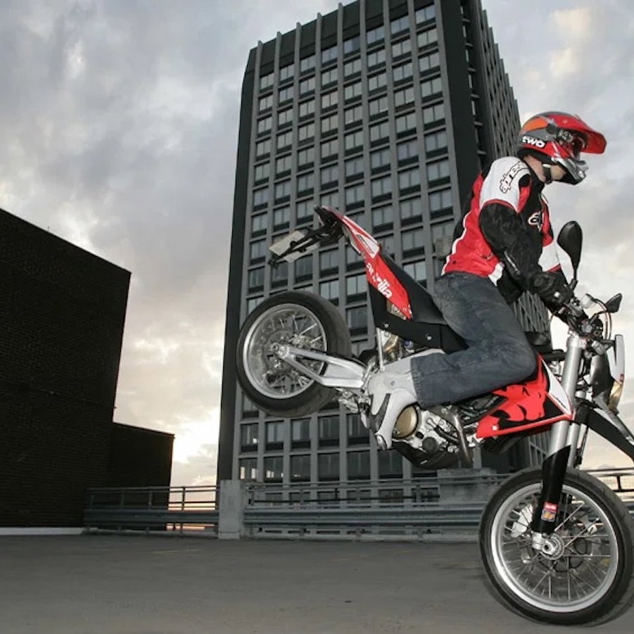 An Aprilia SXV5.5 performing a 'stoppie'